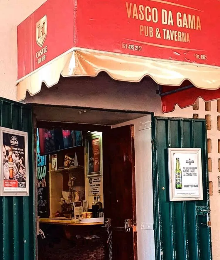 The entrance under the red Vasco da Gama awning
