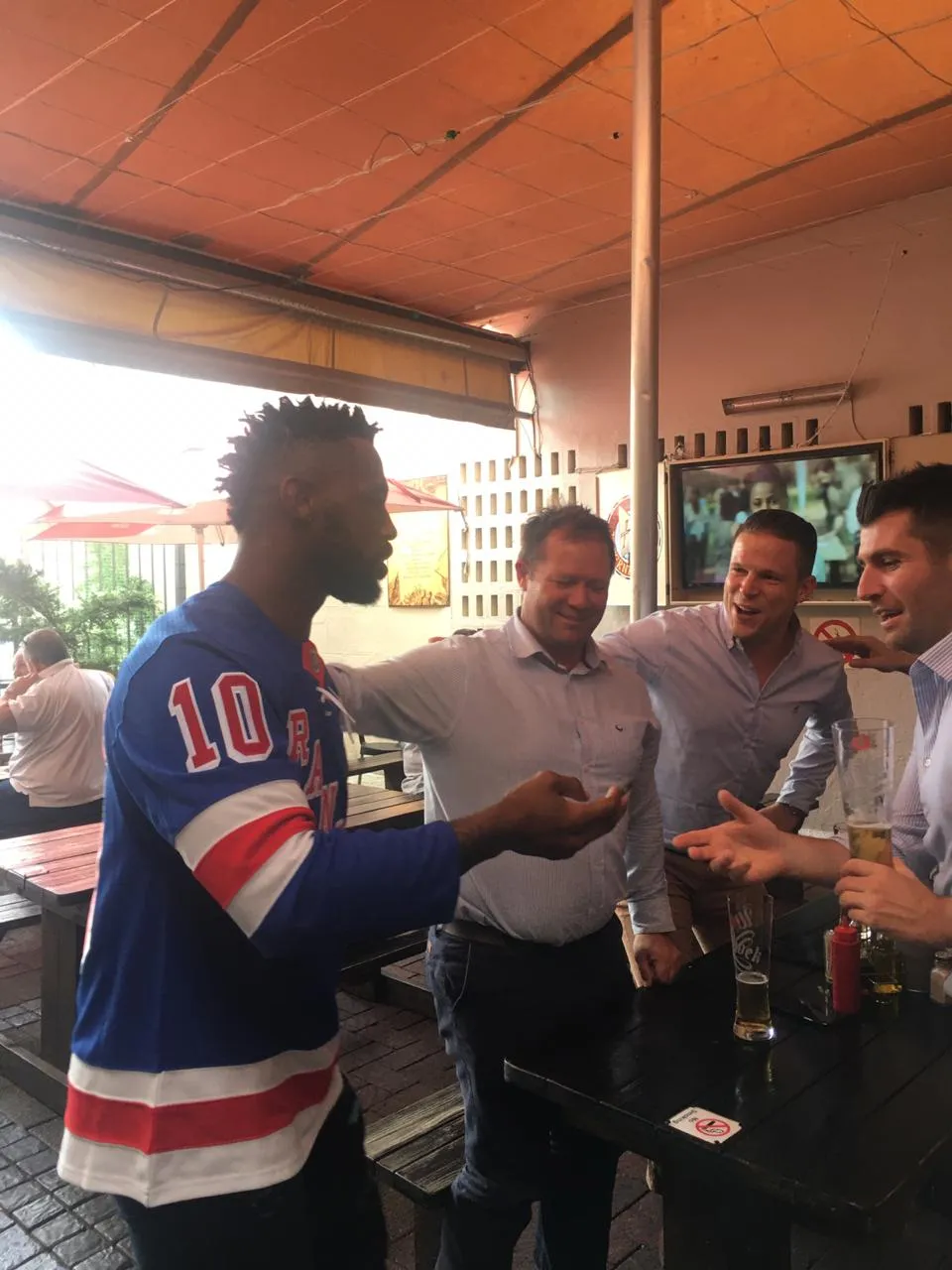 Siya Kolisi with guests in the courtyard