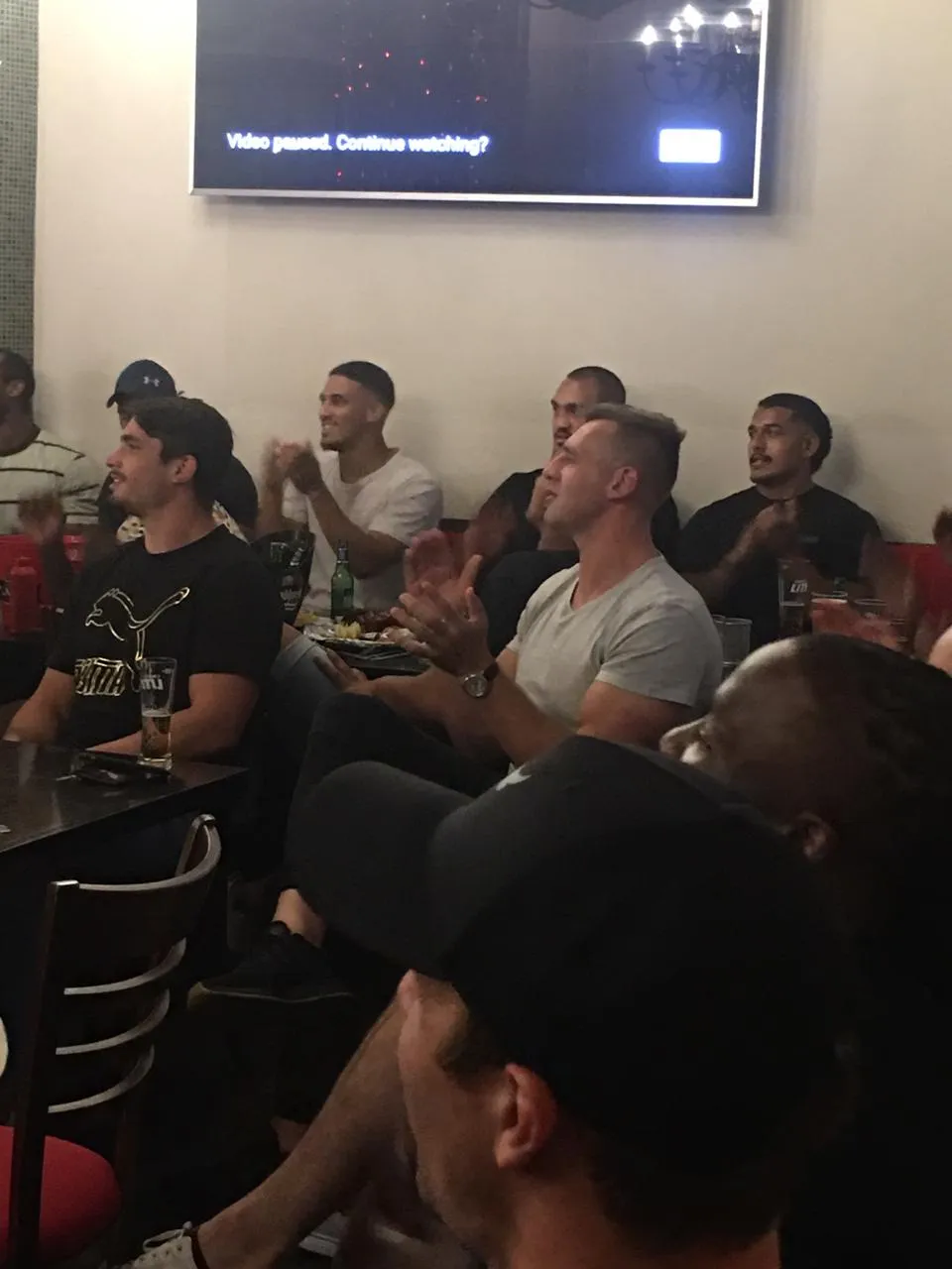 A packed room watching the screens