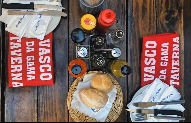 A table with rolls and sauces