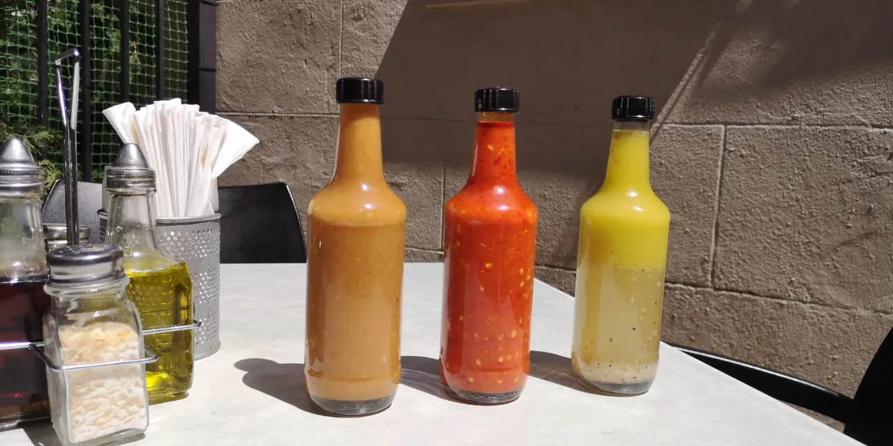 Bottles of Vasco’s sauces on the bar